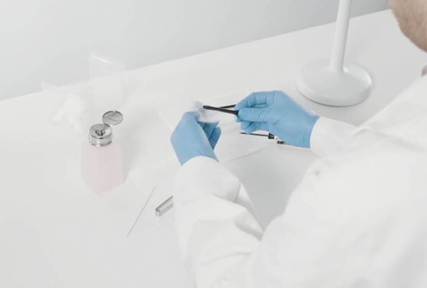 A person in a lab coat holding tweezers

AI-generated content may be incorrect.