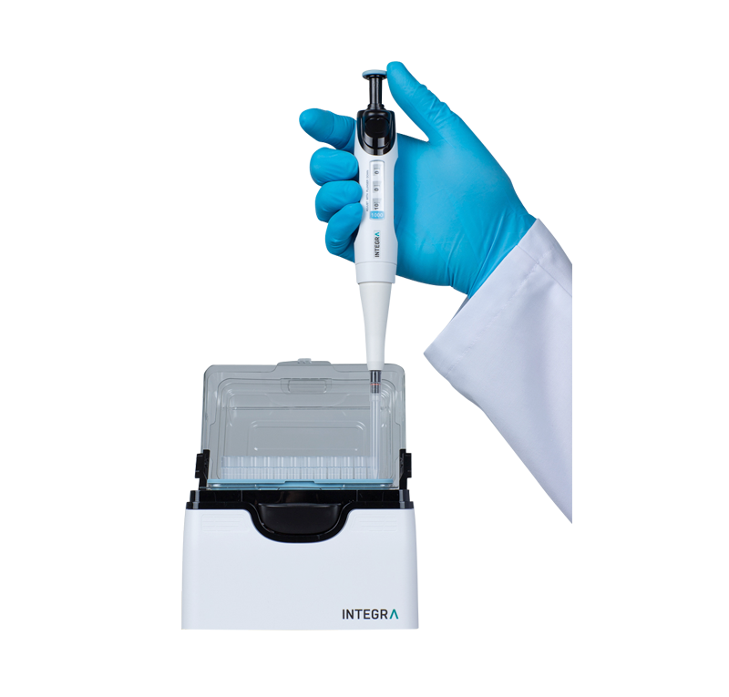 Scientist loading a pipette tip from a PopTop Base with a single channel EVOLVE pipette